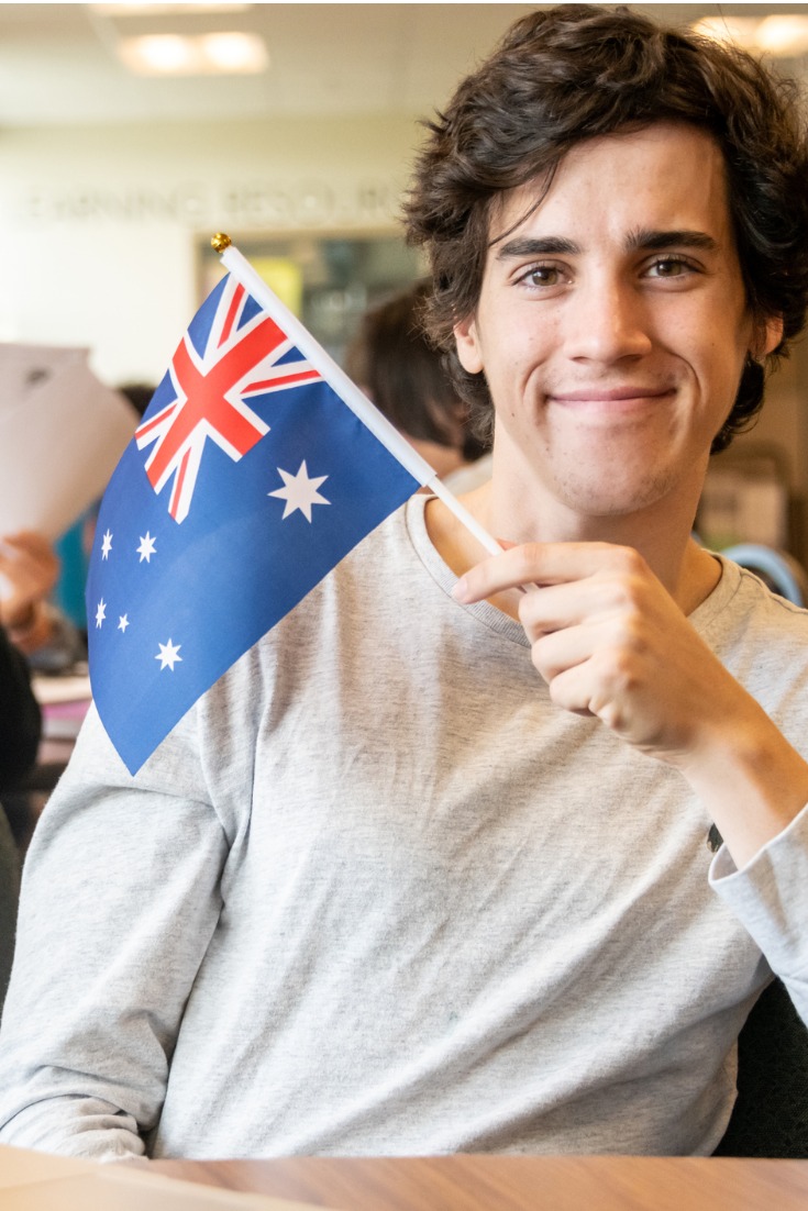 Study In Australia, Cubeloid Overseas Consultants, foreign university, Student holding Australia Flag